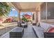 Inviting covered patio with comfortable seating and an outdoor dining area, perfect for entertaining at 15241 W Madison St, Goodyear, AZ 85338