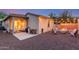 Inviting backyard featuring a cozy outdoor living area with a fire pit and string lights at 15488 W Aster Dr, Surprise, AZ 85379