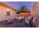 Outdoor gathering space featuring a fire pit, seating, and string lights creating a relaxing ambiance at 15488 W Aster Dr, Surprise, AZ 85379