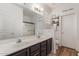 Well-lit bathroom featuring a double vanity, and updated fixtures and accessories at 15488 W Aster Dr, Surprise, AZ 85379