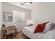 Well-lit bedroom featuring a desk, neutral walls, wood floor, and a comfortable bed at 15488 W Aster Dr, Surprise, AZ 85379