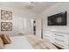 Cozy bedroom with modern decor, white dresser, and ensuite bathroom access at 15488 W Aster Dr, Surprise, AZ 85379