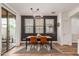 Modern dining area with stylish lighting, wood floors, and access to the backyard at 15488 W Aster Dr, Surprise, AZ 85379