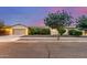 Charming single-story home with well-maintained landscaping and a two-car garage at 15488 W Aster Dr, Surprise, AZ 85379