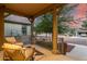 Relaxing covered front porch featuring comfortable chairs and a view of the neighborhood street at 15488 W Aster Dr, Surprise, AZ 85379