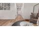 Long hallway with wood floors, white walls, and decorative framed artwork at 15488 W Aster Dr, Surprise, AZ 85379