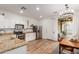 Well-lit kitchen featuring stainless steel appliances, granite countertops, and an adjacent dining area at 15488 W Aster Dr, Surprise, AZ 85379