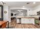 Open-concept kitchen with stainless steel appliances, granite countertops, and access to the living area at 15488 W Aster Dr, Surprise, AZ 85379