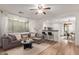 Bright and airy living room featuring an open layout, wood floors, and large windows at 15488 W Aster Dr, Surprise, AZ 85379