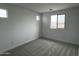 Bedroom featuring three windows and carpeted floors at 17481 W Fulton St, Goodyear, AZ 85338