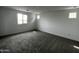 Well-lit bedroom with carpeted floors, neutral paint, and a window providing ample natural light at 17481 W Fulton St, Goodyear, AZ 85338