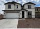 Inviting two-story home with a two-car garage and a well-maintained front yard with desert landscaping at 17481 W Fulton St, Goodyear, AZ 85338