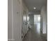 Bright hallway features tile floors, neutral paint, and access to other rooms in the home at 17481 W Fulton St, Goodyear, AZ 85338