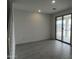 Open living room boasts tile floors, natural light, and a sliding glass door to the patio at 17481 W Fulton St, Goodyear, AZ 85338