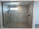 Modern glass shower with marble tile and matte black fixtures inside this home at 17481 W Fulton St, Goodyear, AZ 85338