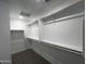 A walk-in closet with white walls and shelving with carpeted floors at 17481 W Fulton St, Goodyear, AZ 85338
