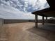 Large backyard enclosed by block wall with a covered patio, offering privacy and potential for customization at 17505 W Fulton St, Goodyear, AZ 85338