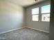 Cozy bedroom with new carpet, neutral walls, and a large window for natural light at 17505 W Fulton St, Goodyear, AZ 85338