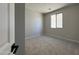 Comfortable bedroom featuring new carpet, neutral walls, and a window at 17505 W Fulton St, Goodyear, AZ 85338