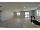 Open-concept living area with tile flooring and plenty of natural light from sliding glass doors at 17505 W Fulton St, Goodyear, AZ 85338