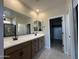 Bathroom boasts double sinks, modern fixtures, and a walk-in closet at 17505 W Fulton St, Goodyear, AZ 85338