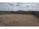 This backyard features fresh dirt and a tall cinder block wall for privacy and security at 17511 W Fulton St, Goodyear, AZ 85338