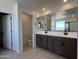 This is a modern bathroom with a double vanity, large mirrors, and a separate toilet room at 17511 W Fulton St, Goodyear, AZ 85338