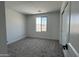 This bedroom includes carpeted floors, a bright window, and a closet with sliding doors at 17511 W Fulton St, Goodyear, AZ 85338
