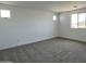 This bedroom features plush gray carpeting, white walls, and plenty of natural light from the windows at 17511 W Fulton St, Goodyear, AZ 85338
