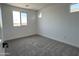 This bedroom offers plush carpeting, neutral walls, and natural light, perfect for relaxation at 17511 W Fulton St, Goodyear, AZ 85338