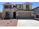 Inviting two-story home featuring a neutral color palette and a spacious two-car garage at 17511 W Fulton St, Goodyear, AZ 85338
