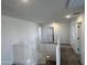 Upstairs landing featuring neutral walls, carpet, and a railing overlooking the staircase at 17511 W Fulton St, Goodyear, AZ 85338
