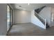 Open-concept living area with tile flooring, sliding glass doors, and access to the staircase at 17511 W Fulton St, Goodyear, AZ 85338