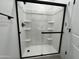 Shower unit with sleek black trim and built in shelving for optimal organization at 17511 W Fulton St, Goodyear, AZ 85338
