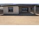 View of the back of the house with an outdoor covered patio and large sliding glass doors at 18168 W Larkspur Dr, Goodyear, AZ 85338