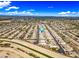 Expansive aerial view of a well-planned community with tidy homes and a scenic canal, all under a clear blue sky at 18495 W Rimrock St, Surprise, AZ 85388