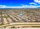 Comprehensive aerial perspective of a neighborhood near a canal, emphasizing its orderly design and serene atmosphere at 18495 W Rimrock St, Surprise, AZ 85388