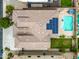 Aerial view of backyard with a swimming pool, hot tub, and large patio, surrounded by lush landscaping at 18495 W Rimrock St, Surprise, AZ 85388