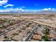 Detailed aerial view of a residential area with lush landscaping, sparkling pools, and desert views at 18495 W Rimrock St, Surprise, AZ 85388