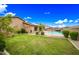 Spacious backyard combining green grass, mature landscaping, and a pool with a spa for outdoor enjoyment at 18495 W Rimrock St, Surprise, AZ 85388