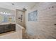 Renovated bathroom featuring dual shower heads, wood tile, river rock floor and mosaic tiled niche at 18495 W Rimrock St, Surprise, AZ 85388