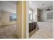 Elegant bathroom with dual sinks, a shower with tub, and modern design at 18495 W Rimrock St, Surprise, AZ 85388