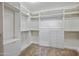 Walk-in closet featuring white shelving, drawers, and hanging rods for ample storage space at 18495 W Rimrock St, Surprise, AZ 85388