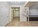 Entryway with tile floors, custom tree design on the wall, and dark wood storage cabinets at 18495 W Rimrock St, Surprise, AZ 85388