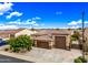 Lovely home showcases desert landscaping, a spacious driveway, and a convenient three-car garage at 18495 W Rimrock St, Surprise, AZ 85388