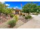 Charming single-story home with desert landscaping, an American flag, and a cozy, inviting curb appeal at 18495 W Rimrock St, Surprise, AZ 85388