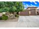 Home with a large three-car garage and a well-maintained driveway for easy access and parking at 18495 W Rimrock St, Surprise, AZ 85388