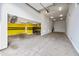 Bright and open garage space with fan and storage cabinets; great for parking and projects at 18495 W Rimrock St, Surprise, AZ 85388