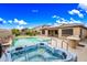 Inviting backyard featuring a hot tub and a private pool with desert landscaping at 18495 W Rimrock St, Surprise, AZ 85388