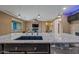 Open kitchen with a granite countertop island overlooking the living area at 18495 W Rimrock St, Surprise, AZ 85388